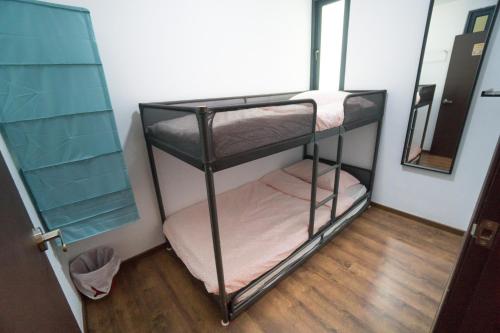 two bunk beds in a room with a mirror at Perfect Getaway @Vivacity in Kuching
