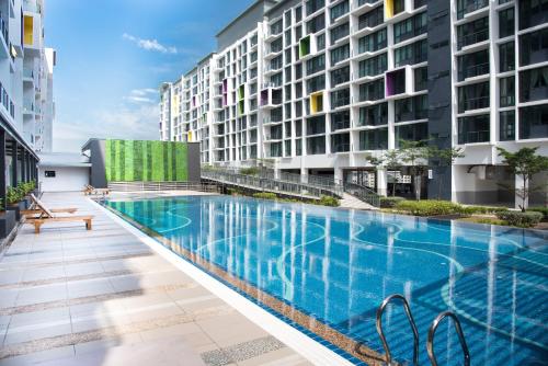 a swimming pool in the middle of a building at Perfect Getaway @Vivacity in Kuching