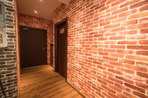 an empty room with a brick wall and a door at Perfect Getaway @Vivacity in Kuching