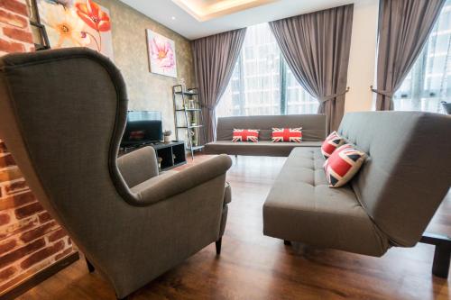 a living room with two chairs and a couch at Perfect Getaway @Vivacity in Kuching