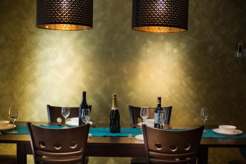 a table with bottles of wine on it with chairs at Perfect Getaway @Vivacity in Kuching