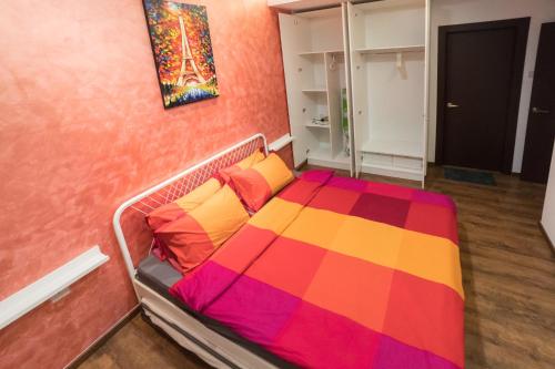 a bedroom with a bed with a colorful blanket at Perfect Getaway @Vivacity in Kuching