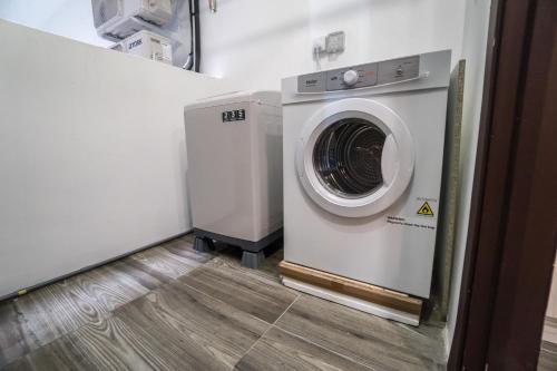 a washer and dryer in a room at Perfect Getaway @Vivacity in Kuching