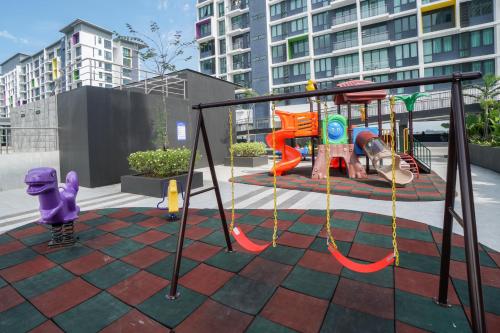a playground with a swing set in a city at Perfect Getaway @Vivacity in Kuching