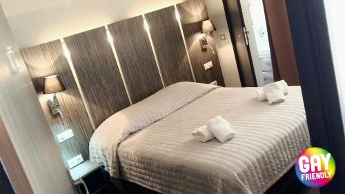 a bedroom with a bed with two towels on it at L'Escale in Bonifacio