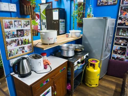 eine Küche mit einer Theke und einem Kühlschrank in der Unterkunft Orchid Haven in Cameron Highlands