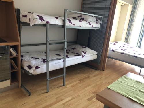 a room with two bunk beds and a table at Apartment Jadranka in Portorož