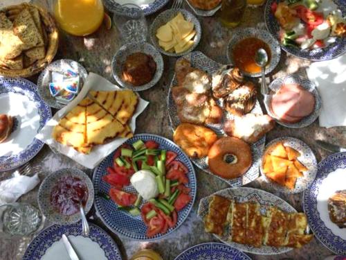 a table with many plates of food on it at Riad Dar Ziryab in Fès