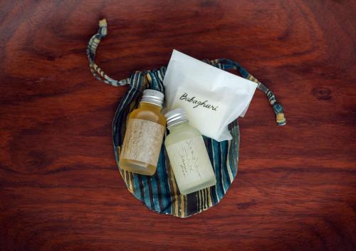 a bag with two bottles on a wooden table at Malda Kyoto in Kyoto