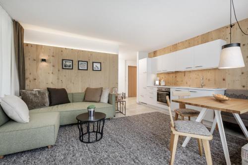 a living room with a couch and a table at Apart am Sonnenhügel in Sautens