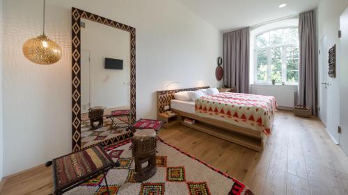 a bedroom with a bed and a large mirror at Gabrium in Maria Enzersdorf