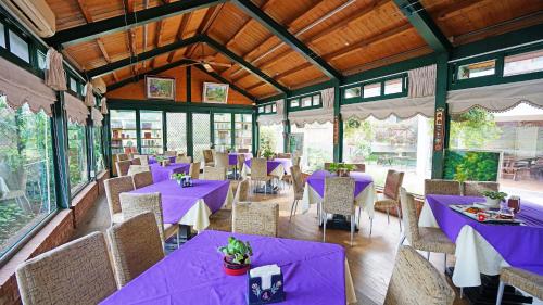 a dining room with purple tables and chairs at Red Brick Villas in Nanzhuang