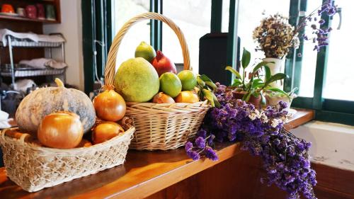 two baskets of fruit on a table with flowers at Red Brick Villas in Nanzhuang