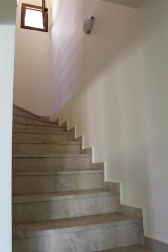 a staircase in a building with a window at Petra in Afitos
