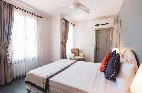 a hotel room with a bed and a window at Kapya Cunda in Ayvalık