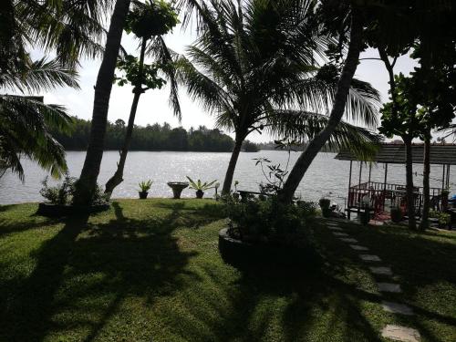 a view of a body of water with palm trees at Mahi Villa in Bentota