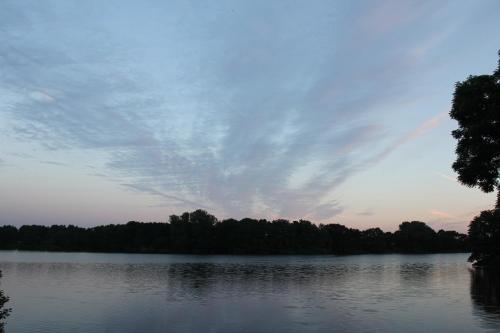 a view of a lake with a cloudy sky at Ferienhaus direkt am Schmalensee in Schmalensee
