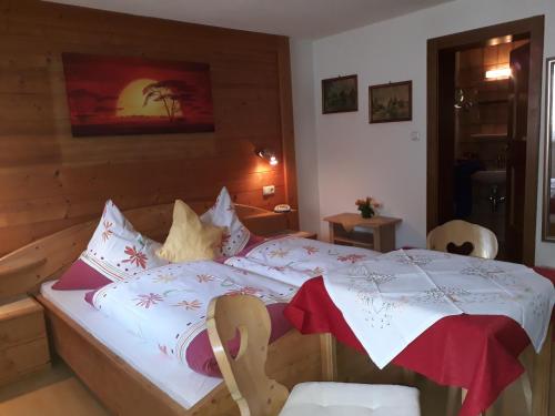 a bedroom with a bed with an umbrella on it at Haus Morgensonne in Pettneu am Arlberg