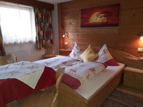 a bedroom with a bed in a log cabin at Haus Morgensonne in Pettneu am Arlberg