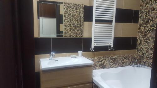 a bathroom with a sink and a tub and a mirror at B&B Inn Centro in Cosenza
