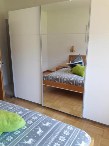 a bedroom with two beds and a mirror at Fewo's Sieberer in Kirchbach