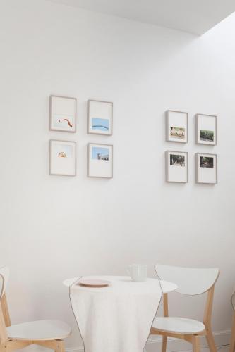 a room with white walls and a table and chairs at Gianburrasca in Florence