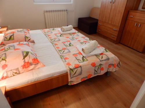 a bedroom with two beds with flowers on them at Apartments Villa Jagoda in Rab