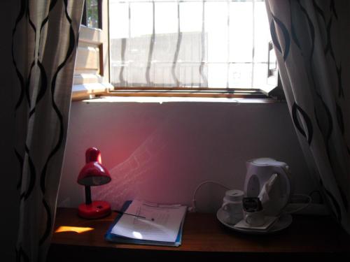 a desk with a lamp and a window at Ronda in Ronda
