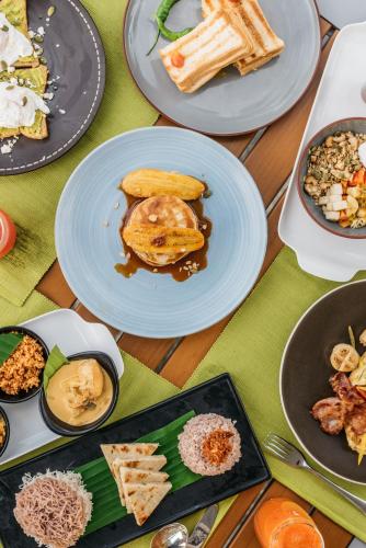 a table full of plates of food on a table at Sielen Diva in Unawatuna