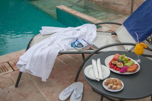 a table with two plates of food on it at The American Colony Hotel - Small Luxury Hotels of the World in Jerusalem