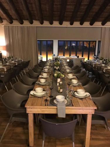a long table in a room with chairs and tablesktop at Water on Waldrift Guesthouse in Vereeniging