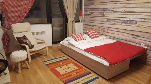 a bedroom with a bed and a chair in it at Papa Moose Pamporovo in Pamporovo