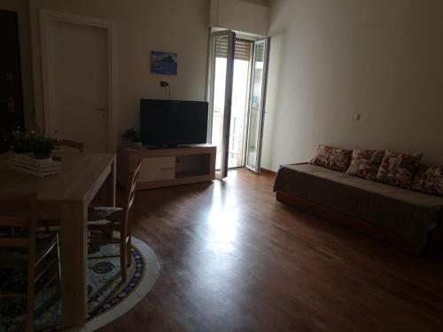 a living room with a couch and a television at La mia Casa in Naples