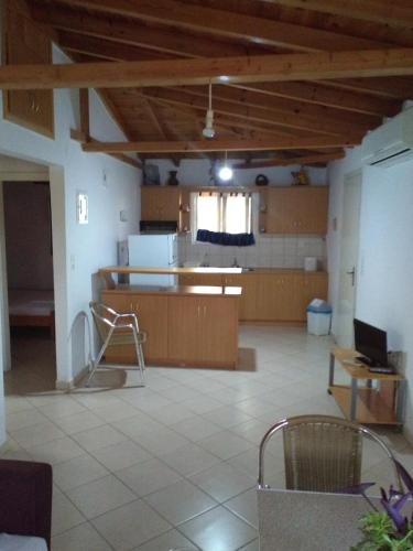 a large room with a table and a laptop on a desk at Klidonas Apartments in Akrogiali