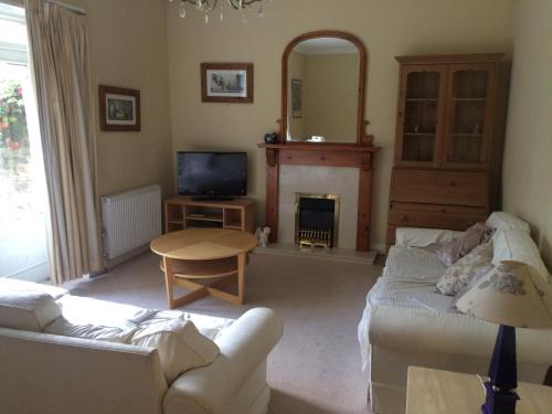 a living room with a couch and a fire place at Newhall in Glasgow
