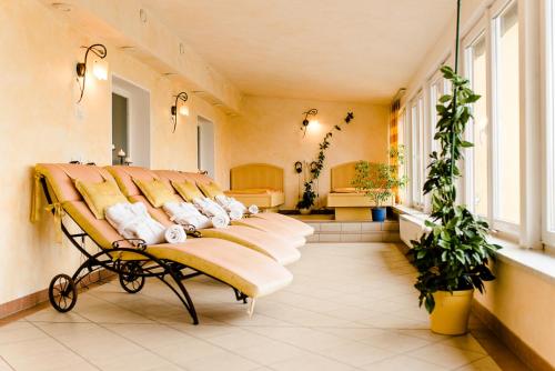 a row of beds in a room with windows at Landhotel Stofflerwirt in Sankt Michael im Lungau