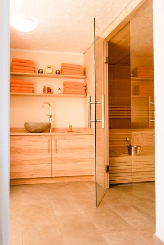 a bathroom with a glass shower and a sink at Landhotel Stofflerwirt in Sankt Michael im Lungau