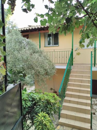 a house with stairs in front of it at Klidonas Apartments in Akrogiali