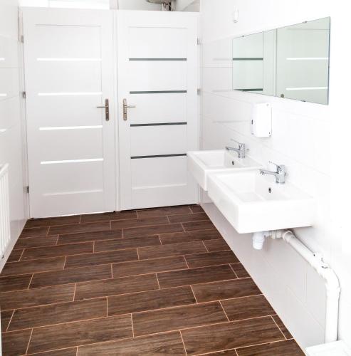 a bathroom with two sinks and two mirrors at MainStation in Gdańsk
