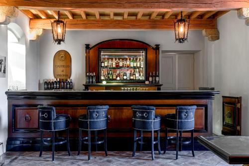 a bar with bar stools in front of it at Castello di Velona Resort, Thermal SPA & Winery in Montalcino