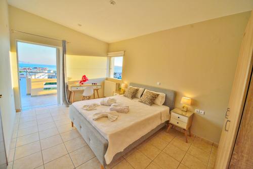 a bedroom with a bed with a view of the ocean at Kissamos View Apartment in Kissamos
