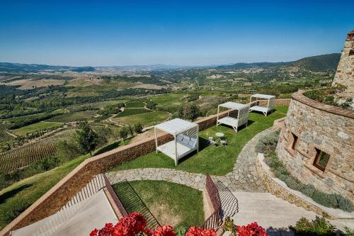 a house with a view of the countryside at Castello di Velona Resort, Thermal SPA & Winery in Montalcino