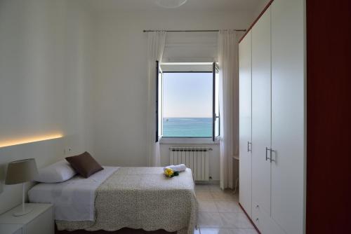 a bedroom with a bed and a large window at Il faro dei poeti in Lerici