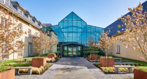 a glass building with a walkway in front of it at Fairmont St Andrews, Scotland in St. Andrews