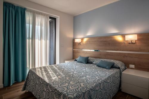 Ένα ή περισσότερα κρεβάτια σε δωμάτιο στο Aparthotel Miramare
