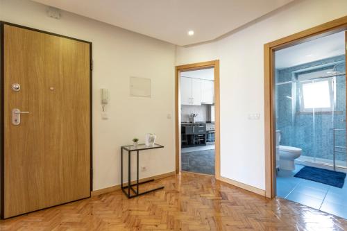 an empty room with a door and a toilet at Like-home Casa Campolide in Lisbon