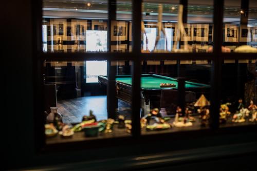 a view of a pool table in a room with toys at Hotel Almhof Schneider in Lech am Arlberg