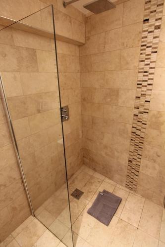 a shower with a glass door in a bathroom at 2 leather lane in Ulverston
