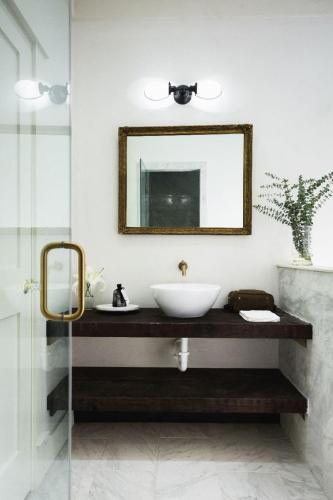 a bathroom with a sink and a mirror at GunRunner Boutique Hotel in Florence