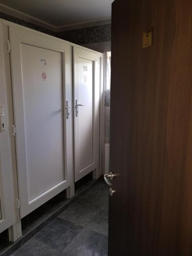 an open door in a hallway with two white doors at Deltix Apartments in Vršac